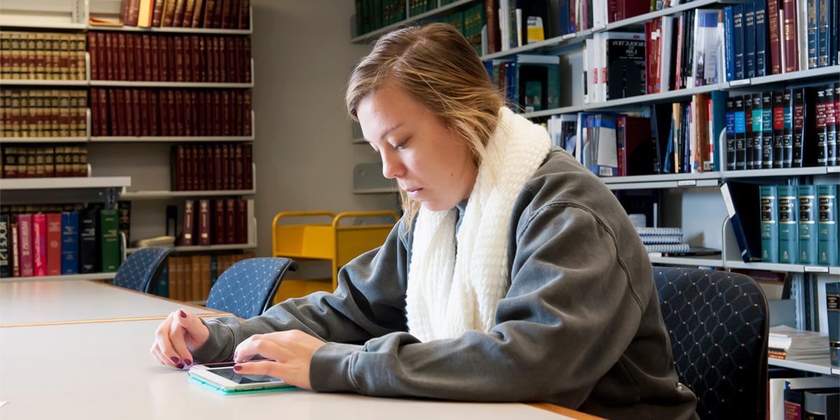 AACC student reading in law library.